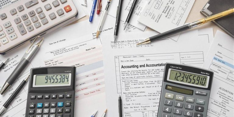 Workspace with accounting tools and paperwork.