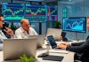 Brokers collaborating in a sleek financial office setting.
