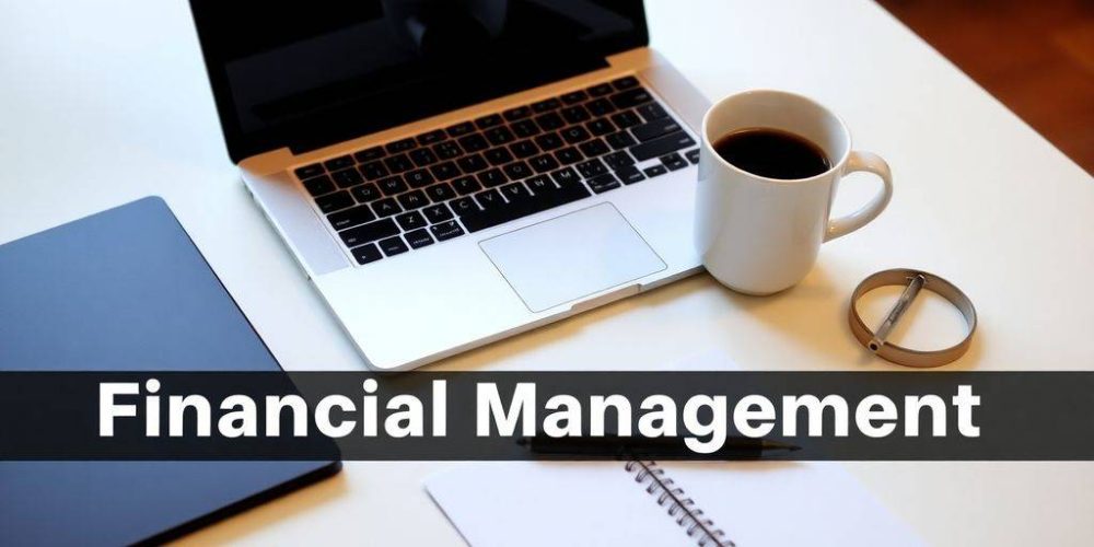 Workspace with laptop, notepad, and coffee cup.