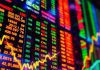 Colorful digital stock ticker display with dynamic movement.