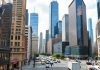 City skyline featuring prominent investment banks and financial buildings.