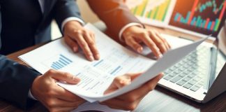 Businessperson reviewing financial documents and charts.