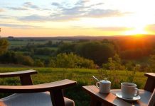 Cozy retirement scene with sunset and coffee cup.