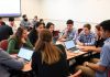 Students engaged in a stock market game in class.