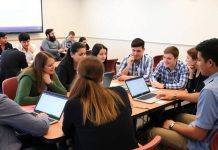 Students engaged in a stock market game in class.