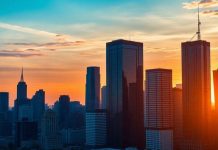 City skyline at sunset representing investment opportunities.