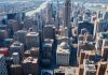 Aerial view of New York City with busy streets and buildings.