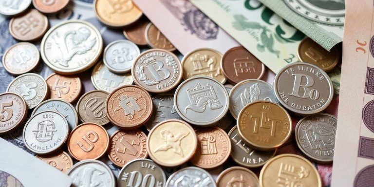 Close-up of diverse coins and banknotes for investment.