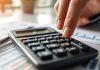 Calculator on financial documents in a modern office.