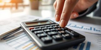 Calculator on financial documents in a modern office.
