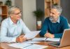 A financial advisor meeting with a client in an office.