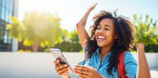 Person using smartphone outdoors, representing financial empowerment.