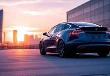 Tesla car in a modern city at sunset.