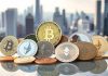 Colorful cryptocurrencies on a reflective surface with city skyline.