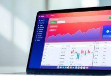 Modern laptop showcasing investment tracking features on screen.