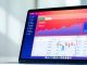 Modern laptop showcasing investment tracking features on screen.