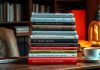 Investment books on a table with a coffee cup.