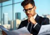 Chief investment officer analyzing financial documents in an office.