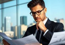 Chief investment officer analyzing financial documents in an office.