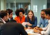 Professionals discussing private equity in a modern office.