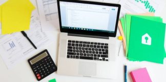 Workspace with laptop and financial documents for analysis.