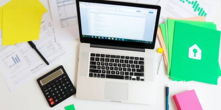 Workspace with laptop and financial documents for analysis.