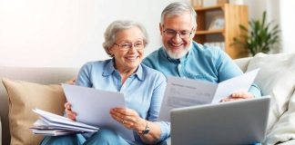 Happy couple discussing retirement plans at home.