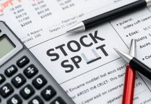 Calculator and pen on a financial newspaper about stocks.