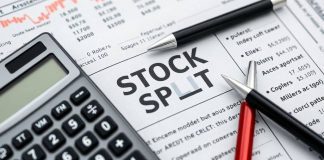 Calculator and pen on a financial newspaper about stocks.