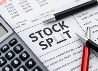 Calculator and pen on a financial newspaper about stocks.
