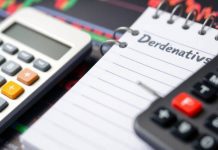 Calculator and notepad focused on financial derivatives concept.