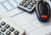 Calculator with vehicle keys on a budget planning surface.