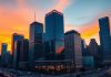 City skyline at dusk highlighting financial district buildings.