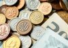 Assorted coins and banknotes representing investment and economy.
