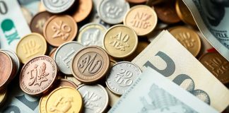 Assorted coins and banknotes representing investment and economy.