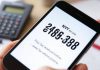 Close-up of a smartphone showing tax refund hotline number.
