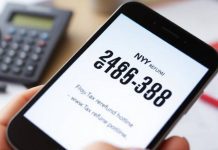 Close-up of a smartphone showing tax refund hotline number.