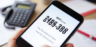 Close-up of a smartphone showing tax refund hotline number.