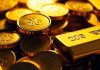 Gold coins and bars glowing in soft, inviting light.
