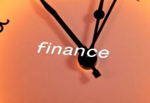 Close-up of a clock with currency symbols integrated.