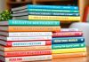 Books on hedge funds arranged on a wooden table.