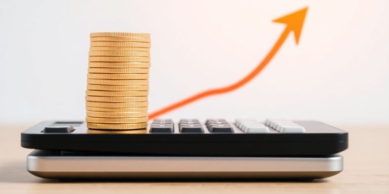 Coins stacked on a calculator with a rising arrow.