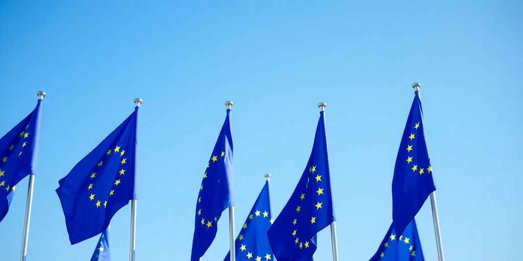 European flags waving under blue sky.