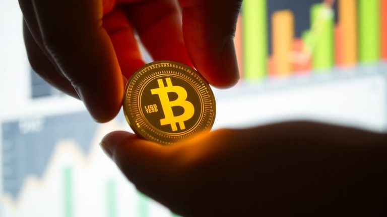 Golden coin held in hand, symbolizing financial return.