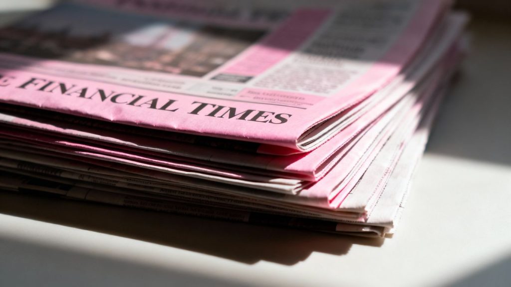 Financial Times newspapers stacked, close-up view.