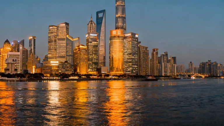 Shanghai skyline at dusk with financial district buildings.