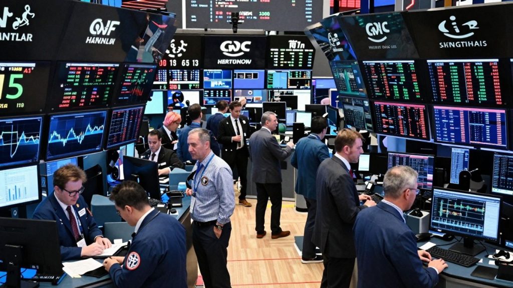 Stock market trading floor with active traders and digital displays.