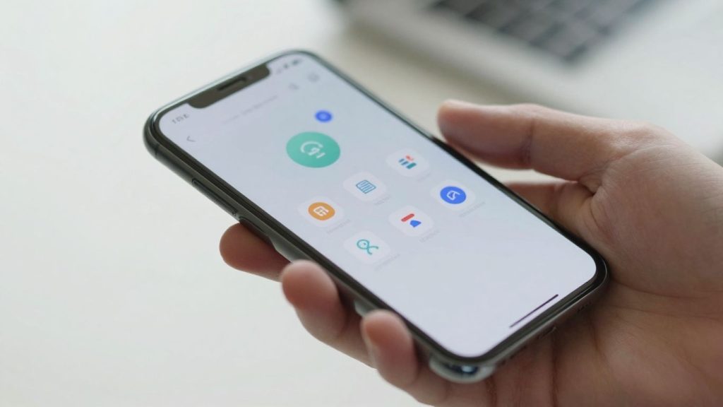 Hand holding smartphone with financial app